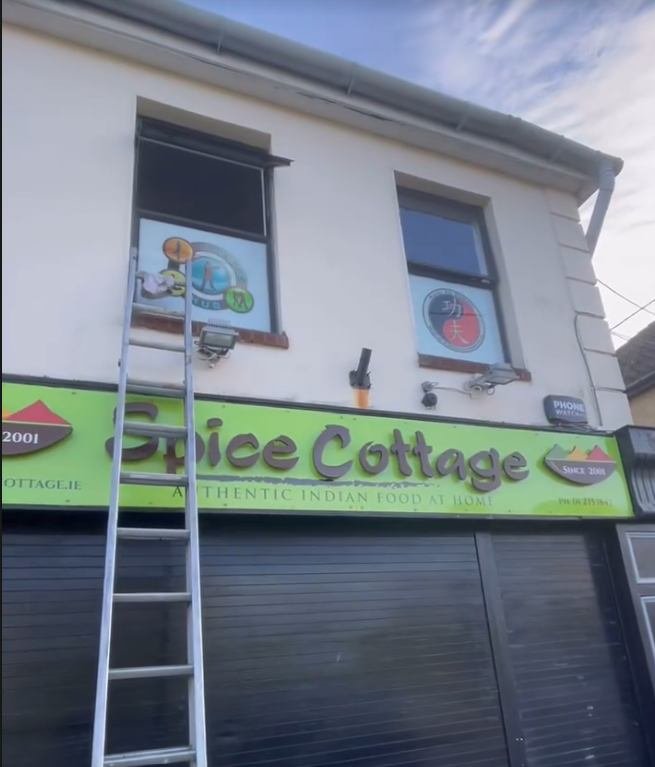 Restaurant upper windows cleaned by ladder