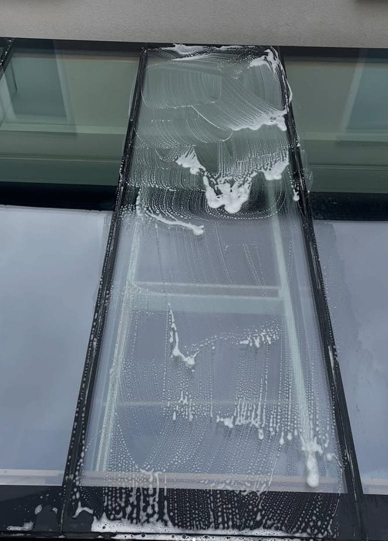 Window being cleaned with pure water